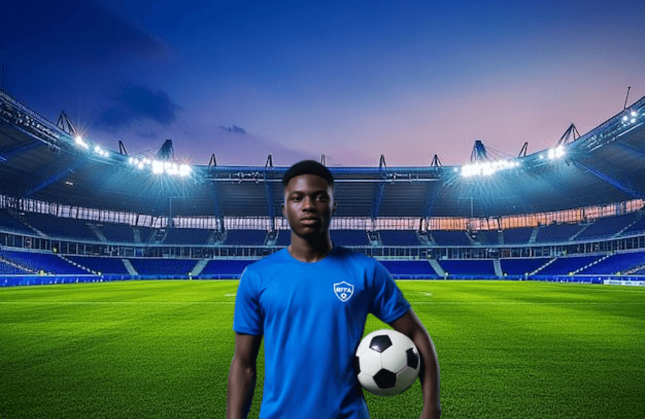 Young player holding football in stadium